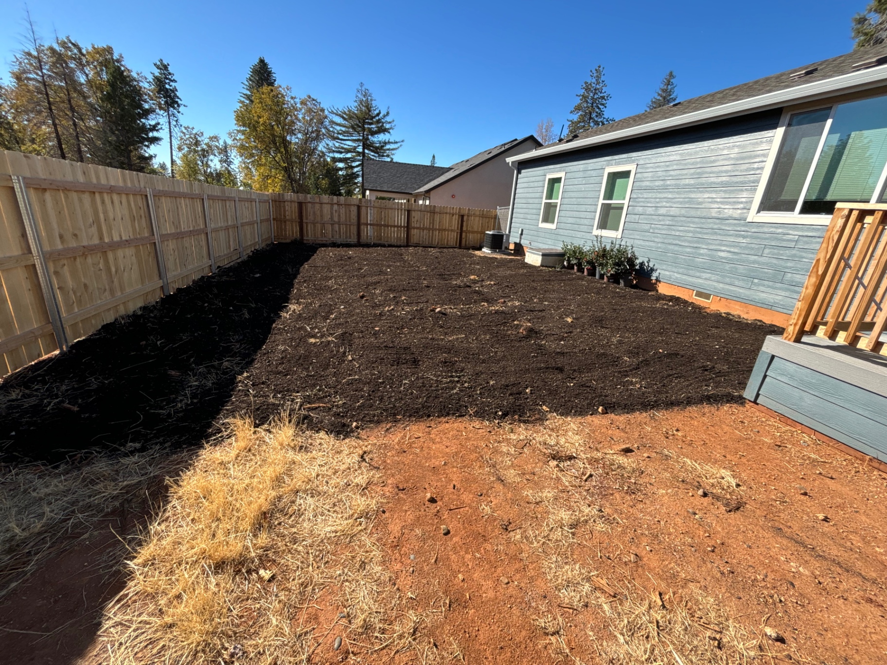 Backyard graded to bare soil before sod installation